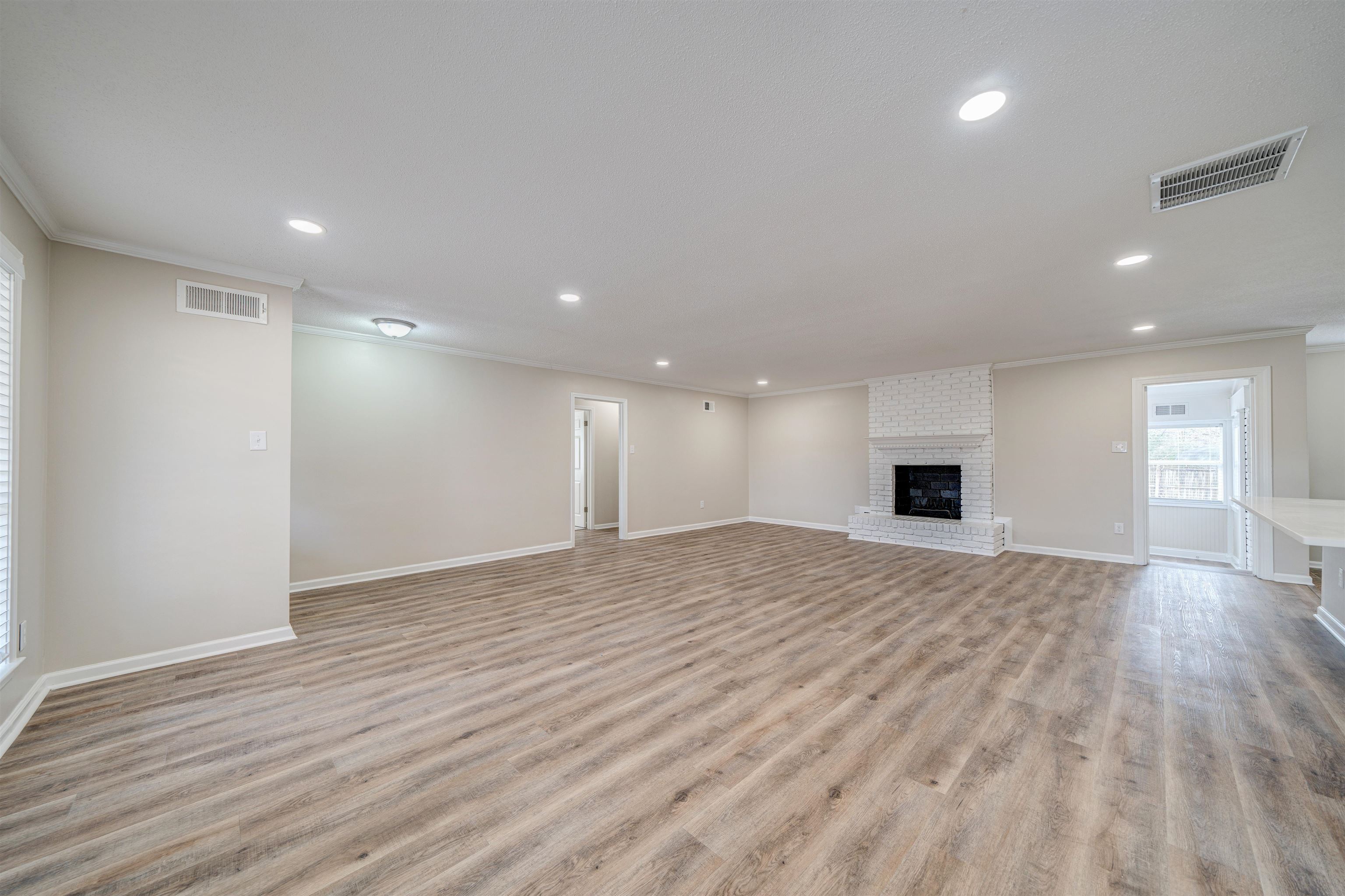 2487 Lynnfield Road Memphis, TN 38119 - Photo 5 of 33 a view of empty room with wooden floor and window