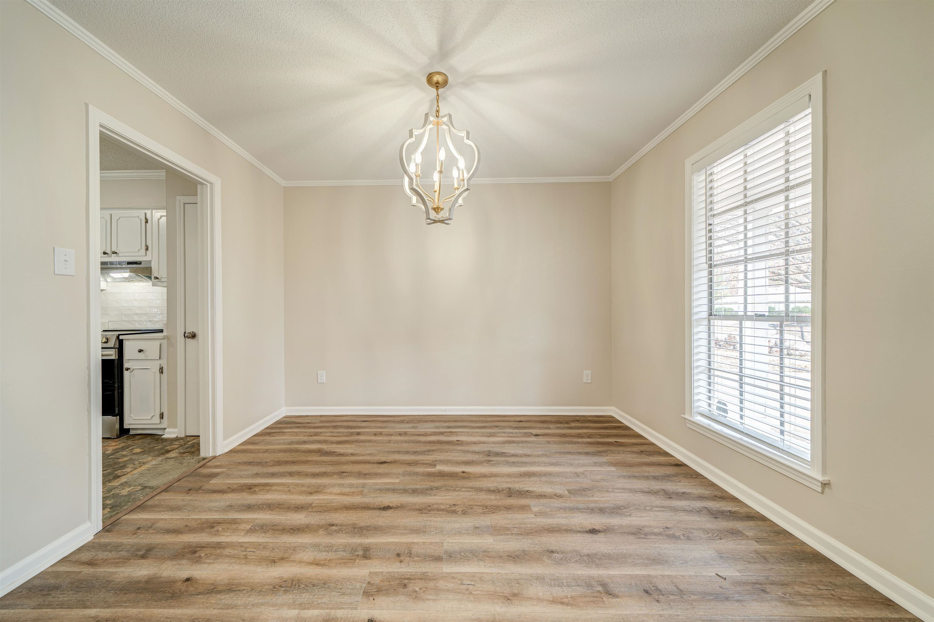 2487 Lynnfield Road Memphis, TN 38119 - Photo 7 of 33 wooden floor in an empty room with a window