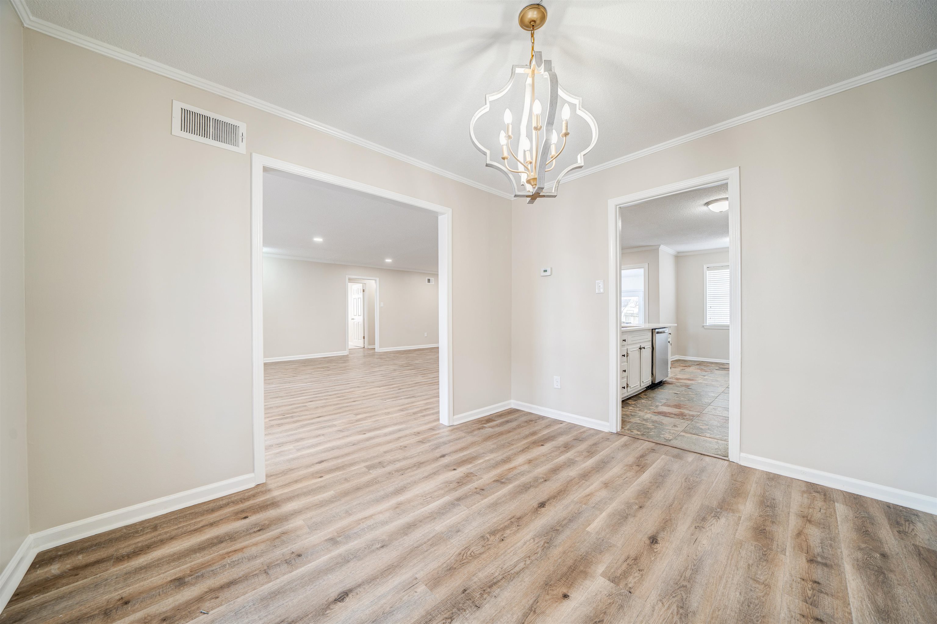 2487 Lynnfield Road Memphis, TN 38119 - Photo 8 of 33 a view of a hallway with wooden floor and chandelier