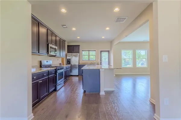 a view of kitchen with sink and wooden floor
