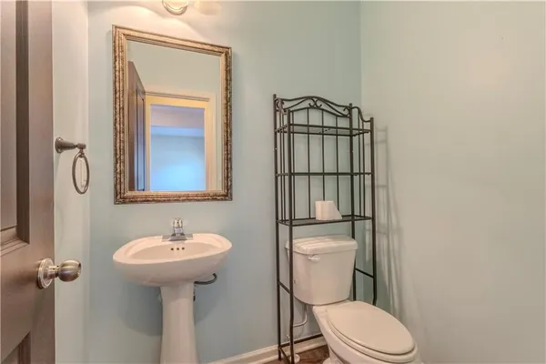 a bathroom with a toilet sink shower and mirror