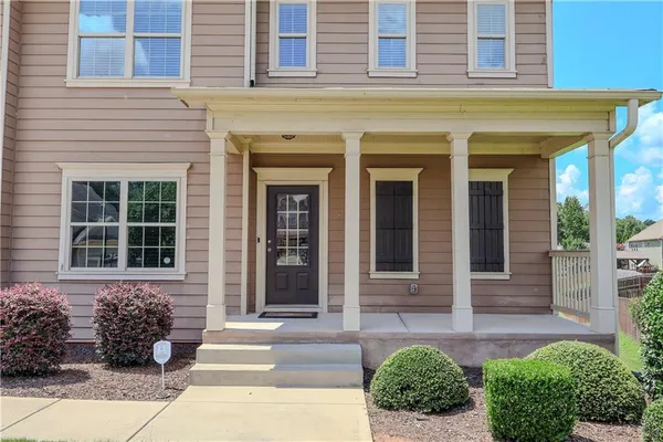 a couple of potted plants in front of a house