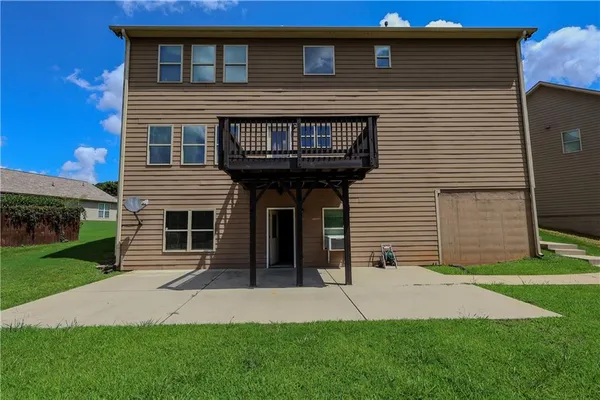 a front view of a house with a garden and yard