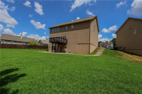 a view of a house with a backyard