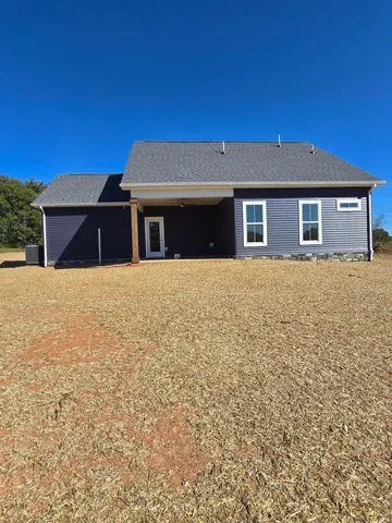 a house that has a tree in front of it