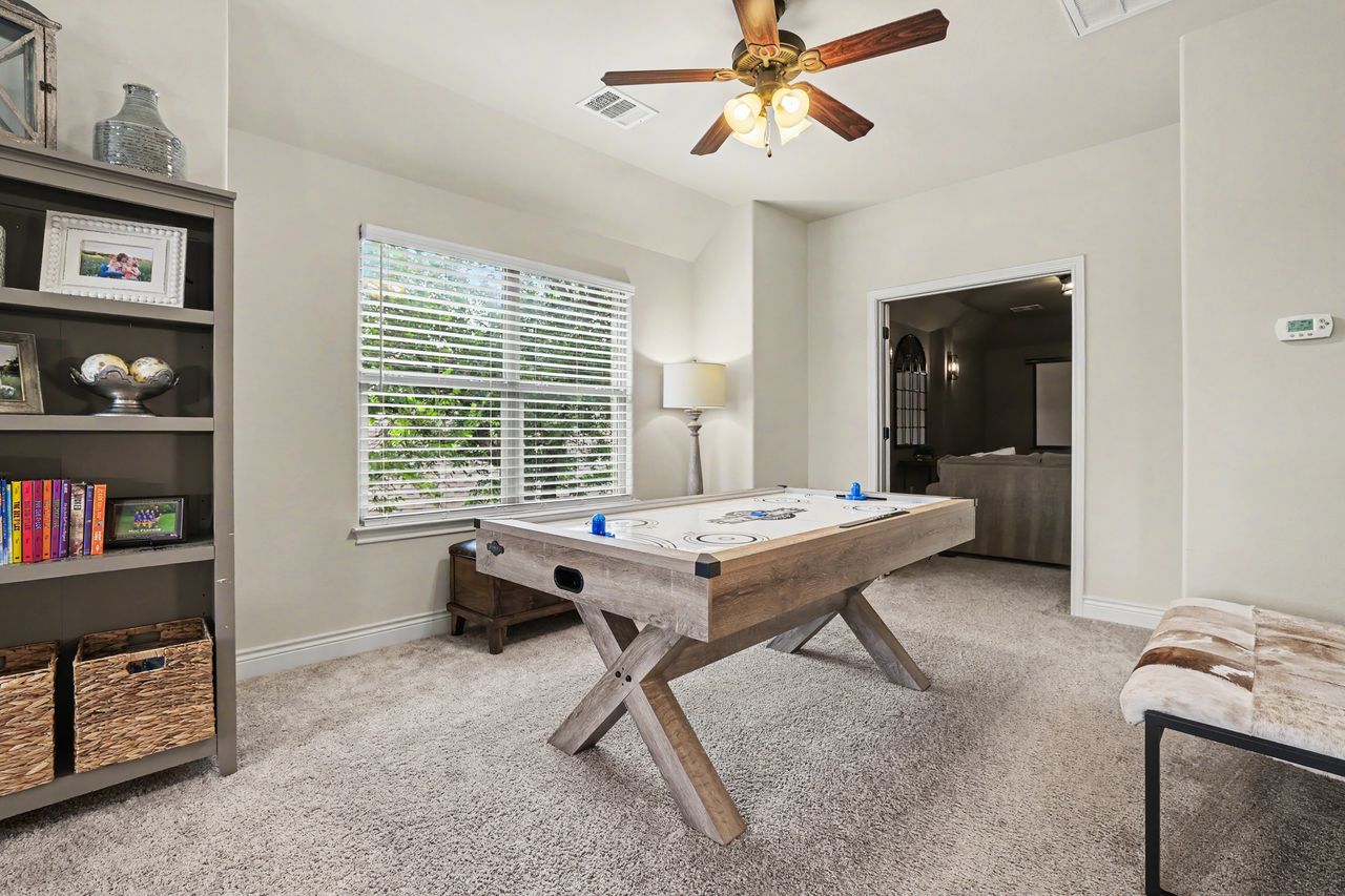 809 Prairie Dunes Drive Georgetown, TX 78628 - Photo 23 of 40 A dedicated game room featuring a durable air hockey table and ample natural light through wide windows.