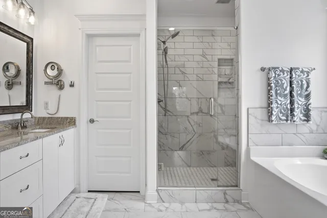 a bathroom with a tub and shower