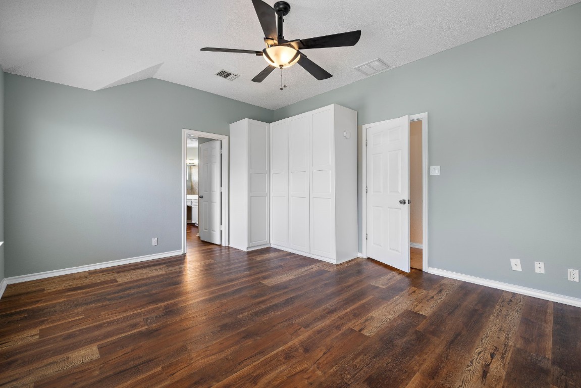 1815 Rusty Nail Loop Round Rock, TX 78681 - Photo 13 of 27 a view of an empty room with wooden floor