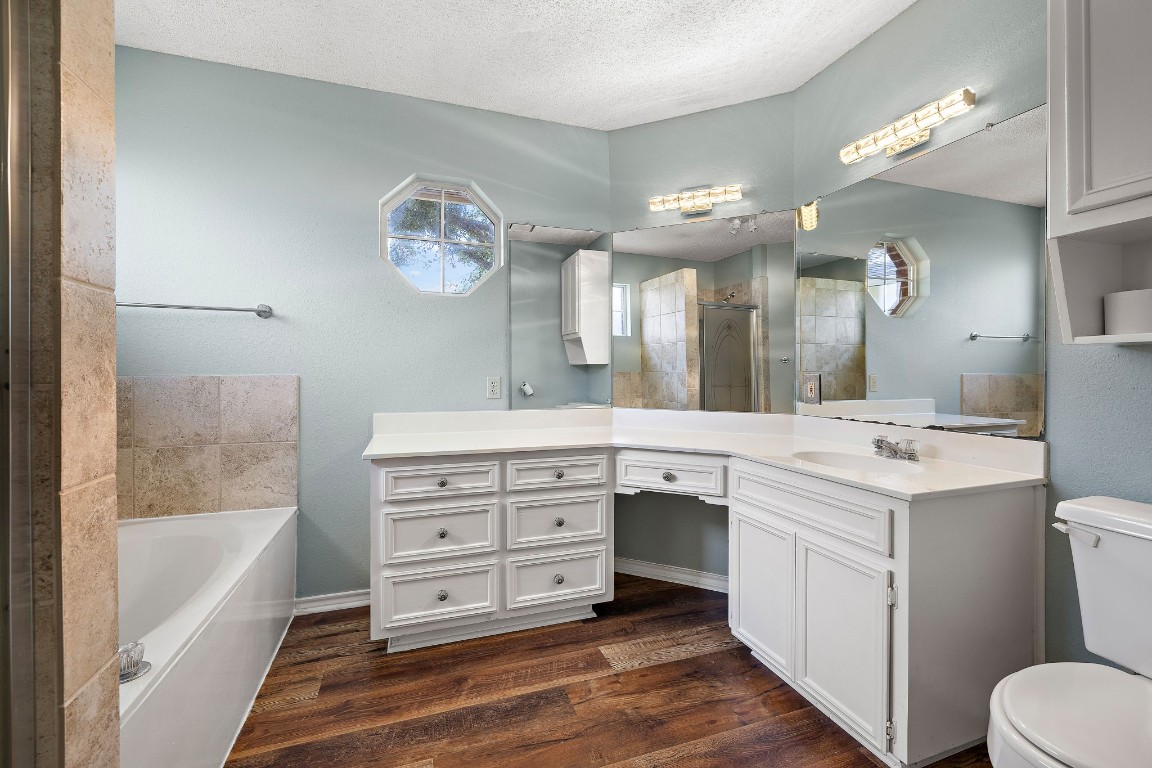 1815 Rusty Nail Loop Round Rock, TX 78681 - Photo 14 of 27 a spacious bathroom with a tub double vanity sink and a mirror