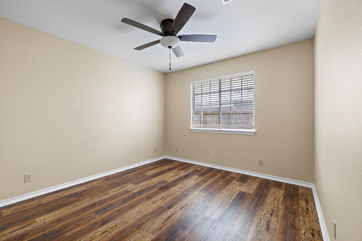 1815 Rusty Nail Loop Round Rock, TX 78681 - Photo 16 of 27 an empty room with wooden floor and windows