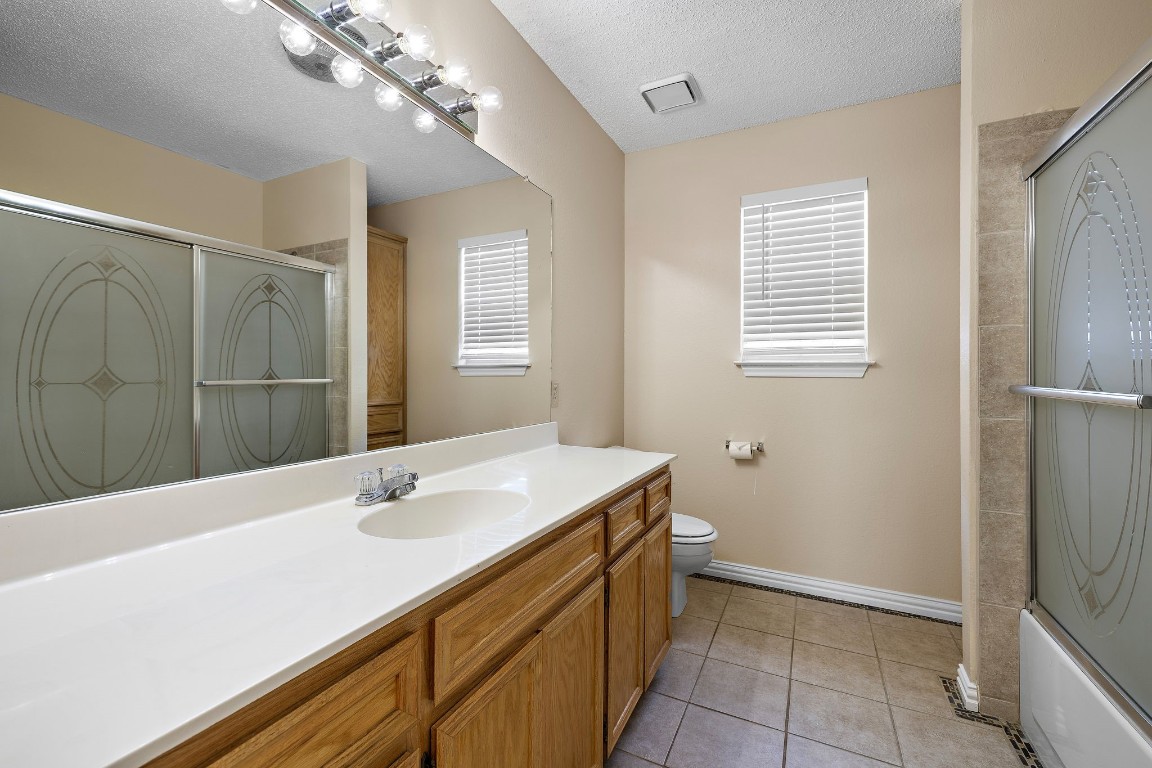 1815 Rusty Nail Loop Round Rock, TX 78681 - Photo 17 of 27 a bathroom with a sink a vanity and a mirror