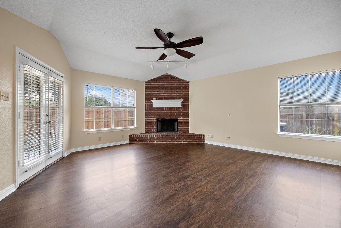 1815 Rusty Nail Loop Round Rock, TX 78681 - Photo 2 of 27 a view of wooden floor fire place and windows in a room