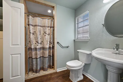 a bathroom with a toilet sink and shower