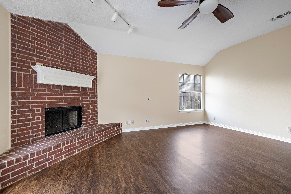 1815 Rusty Nail Loop Round Rock, TX 78681 - Photo 3 of 27 a view of an empty room with wooden floor fireplace and a window