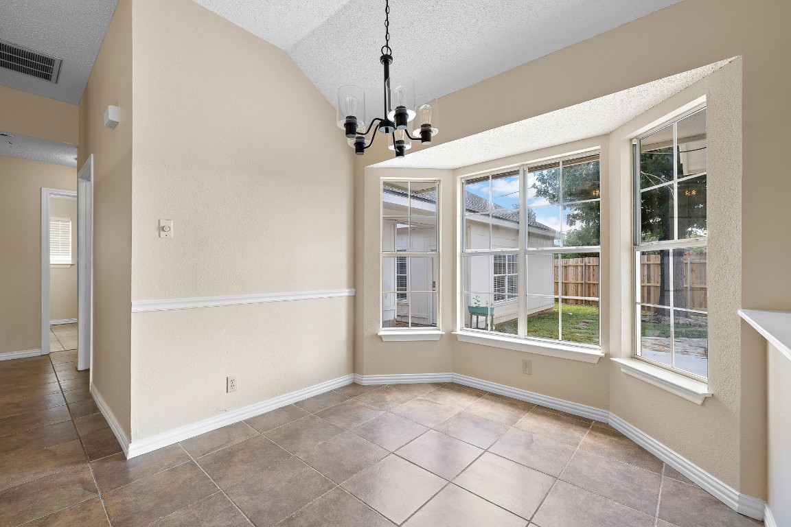 1815 Rusty Nail Loop Round Rock, TX 78681 - Photo 5 of 27 a view of an empty room with a window and chandelier
