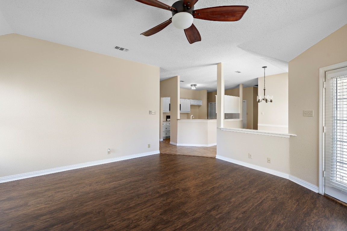 1815 Rusty Nail Loop Round Rock, TX 78681 - Photo 8 of 27 a view of a kitchen with wooden floor and a ceiling fan