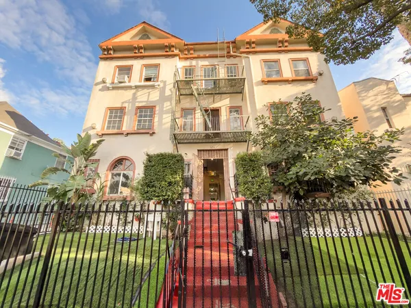 a view of a brick house with many windows