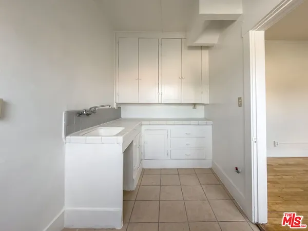 a utility room with sink washer and dryer