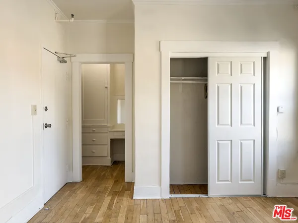 a view of empty room with wooden floor