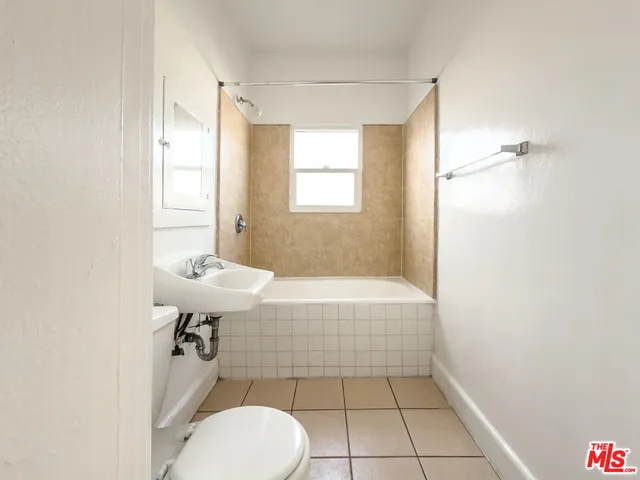 a bathroom with a sink a toilet and bathtub