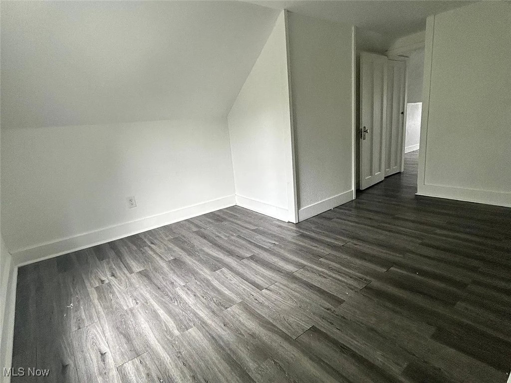 13902 Coit Road Cleveland, OH 44110 - Photo 14 of 17 Additional living space featuring dark hardwood / wood-style floors and lofted ceiling