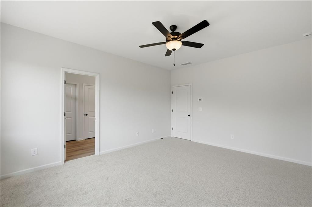 299 Summit View Lane, Unit 5 Jasper, GA 30143 - Photo 23 of 43 an empty room with a ceiling fan and window