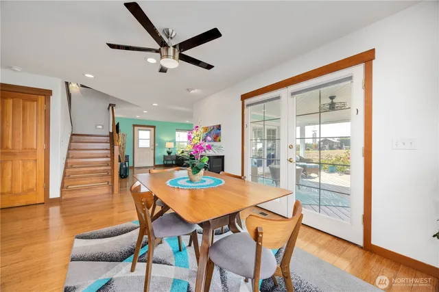 a dining room with furniture and wooden floor