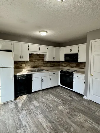 a kitchen with stainless steel appliances granite countertop a stove cabinets and a refrigerator