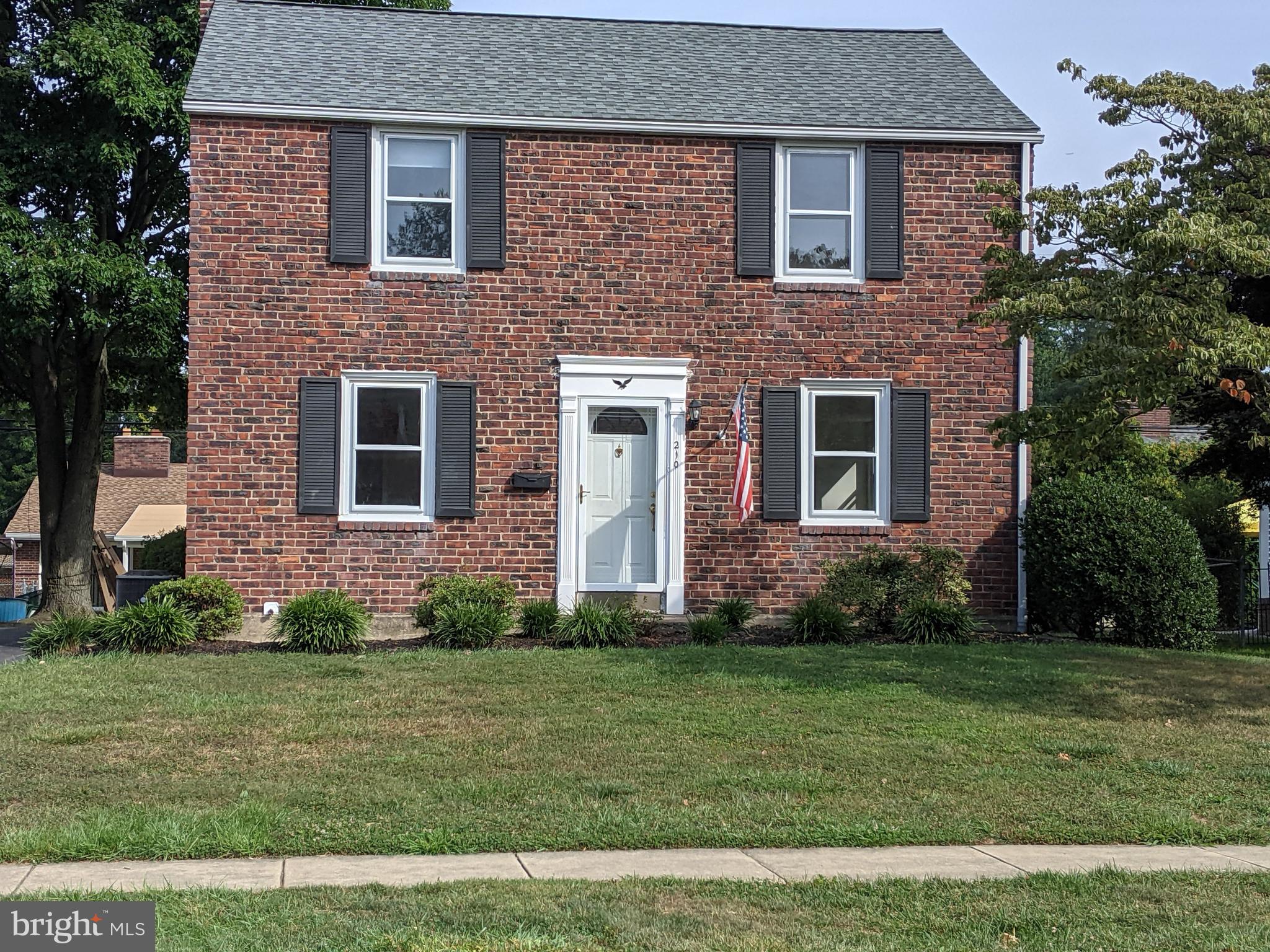 Classic Brick Colonial on a beautiful street.
