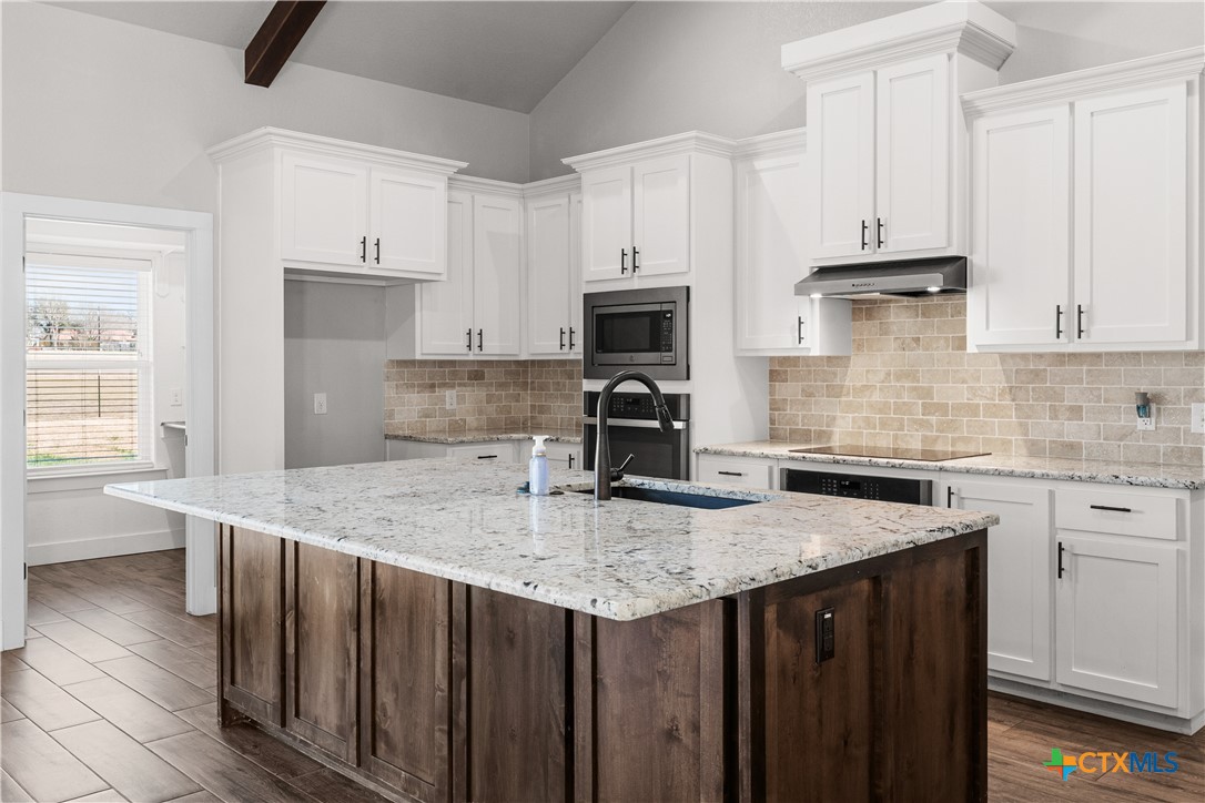 15020 Old Troy Road Troy, TX 76579 - Photo 17 of 48 a kitchen with stainless steel appliances granite countertop a sink stove and refrigerator