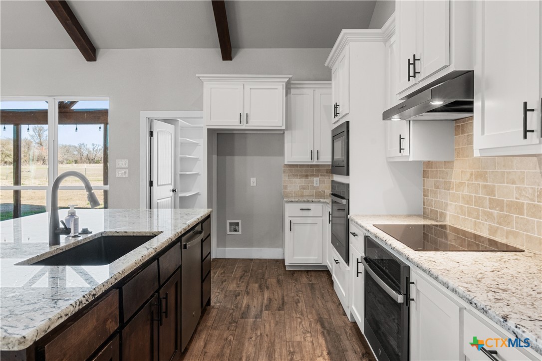 15020 Old Troy Road Troy, TX 76579 - Photo 18 of 48 a kitchen with stainless steel appliances granite countertop a sink stove and refrigerator