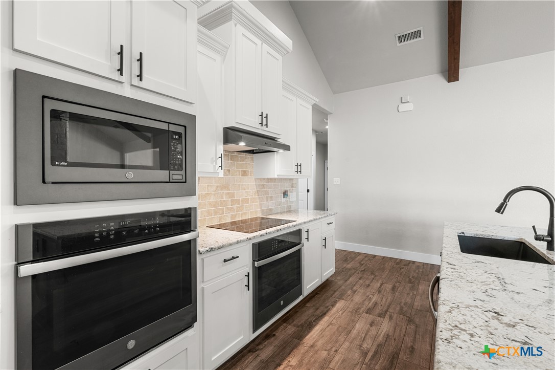 15020 Old Troy Road Troy, TX 76579 - Photo 20 of 48 a kitchen with stainless steel appliances a stove a microwave and a hard wood floor