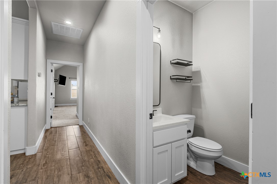 15020 Old Troy Road Troy, TX 76579 - Photo 29 of 48 a bathroom with a toilet sink and vanity