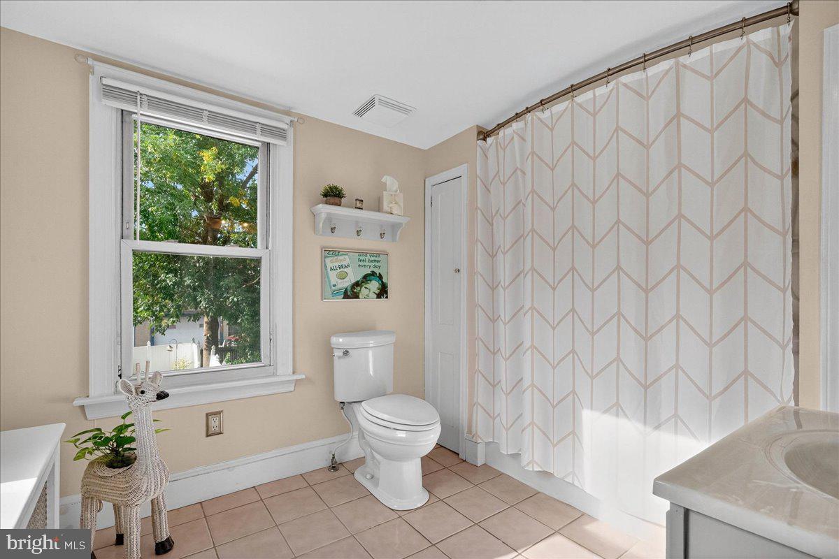 54 Chestnut Street Pottstown, PA 19464 - Photo 28 of 44 a white toilet sitting next to a shower curtain