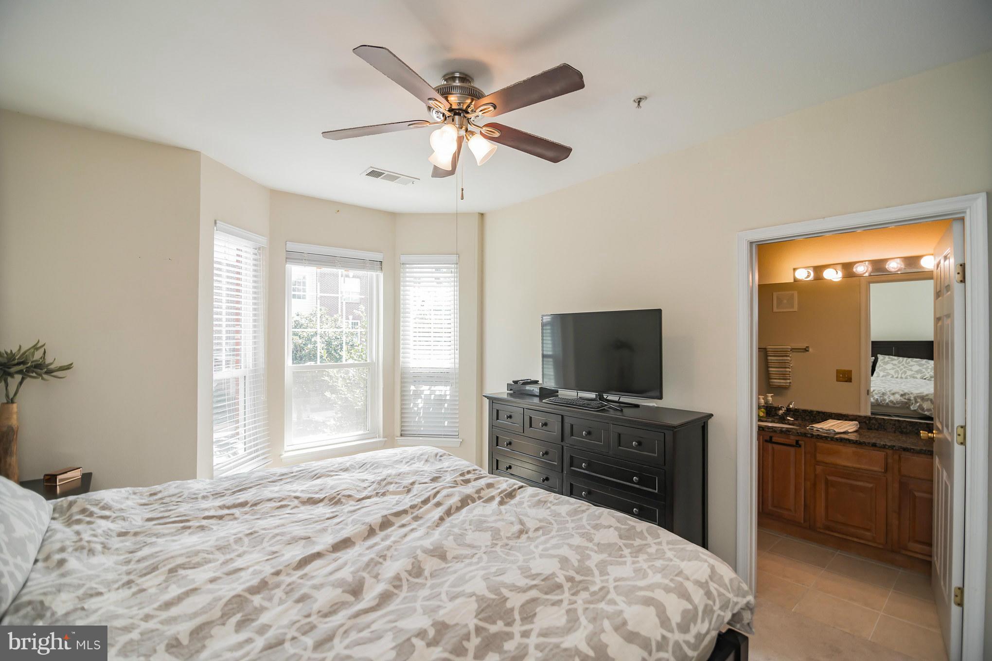 1600 Spring Gate Dr., Unit 2215 McLean, VA 22102 - Photo 19 of 30 a bedroom with a bed and a flat screen tv