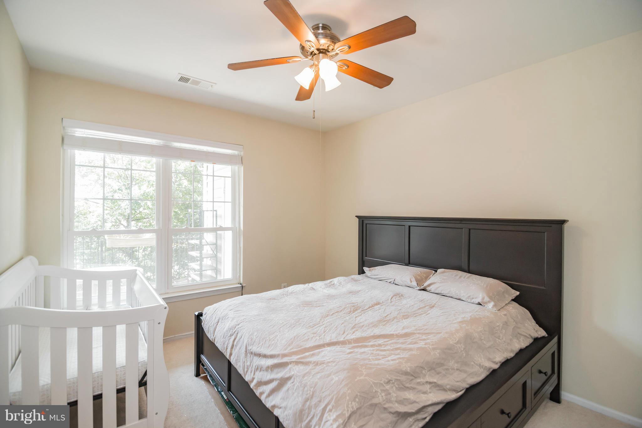 1600 Spring Gate Dr., Unit 2215 McLean, VA 22102 - Photo 21 of 30 a bedroom with a bed and a large window
