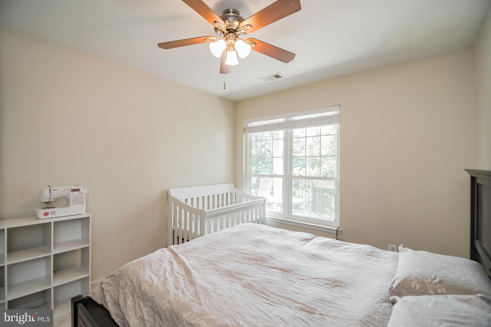 1600 Spring Gate Dr., Unit 2215 McLean, VA 22102 - Photo 22 of 30 a bedroom with a bed and a window