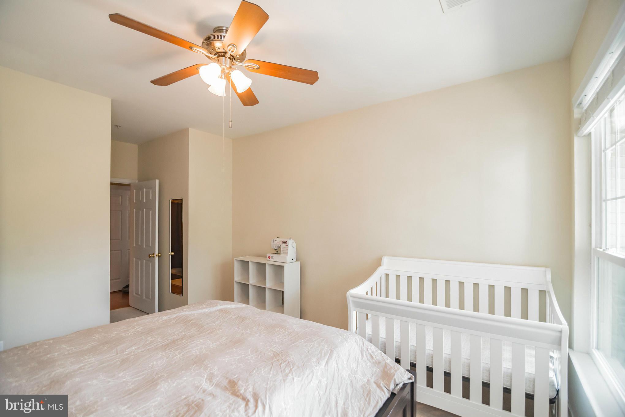 1600 Spring Gate Dr., Unit 2215 McLean, VA 22102 - Photo 23 of 30 a bedroom with a bed and a chandelier