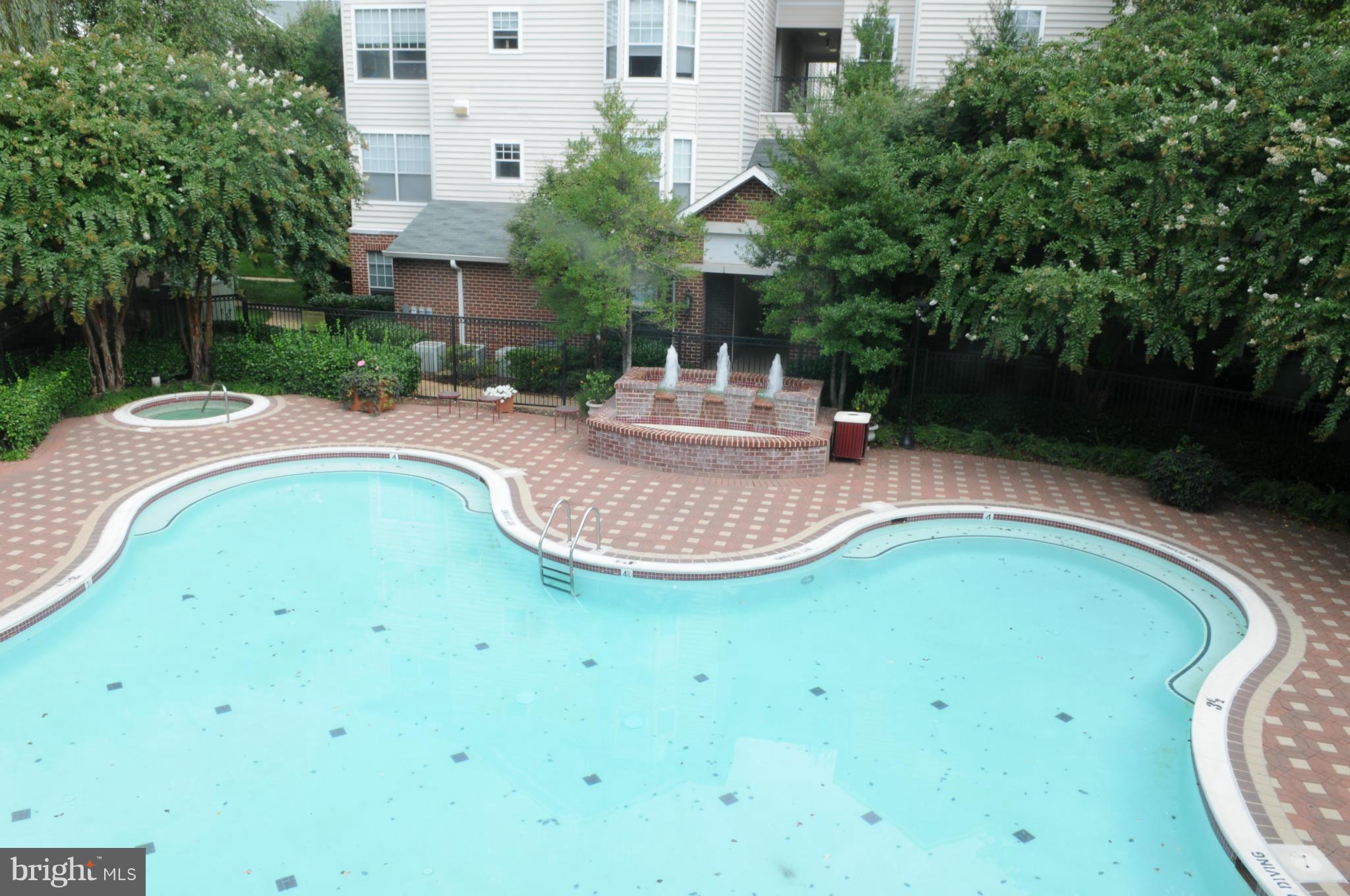 1600 Spring Gate Dr., Unit 2215 McLean, VA 22102 - Photo 26 of 30 a view of a swimming pool with a garden