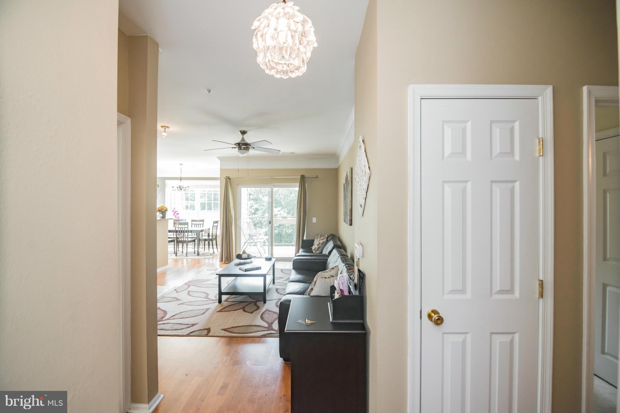 1600 Spring Gate Dr., Unit 2215 McLean, VA 22102 - Photo 5 of 30 a view of a livingroom and a dining table & chairs