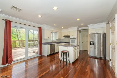 a large kitchen with a large window and stainless steel appliances