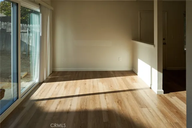 a view of an empty room with wooden floor
