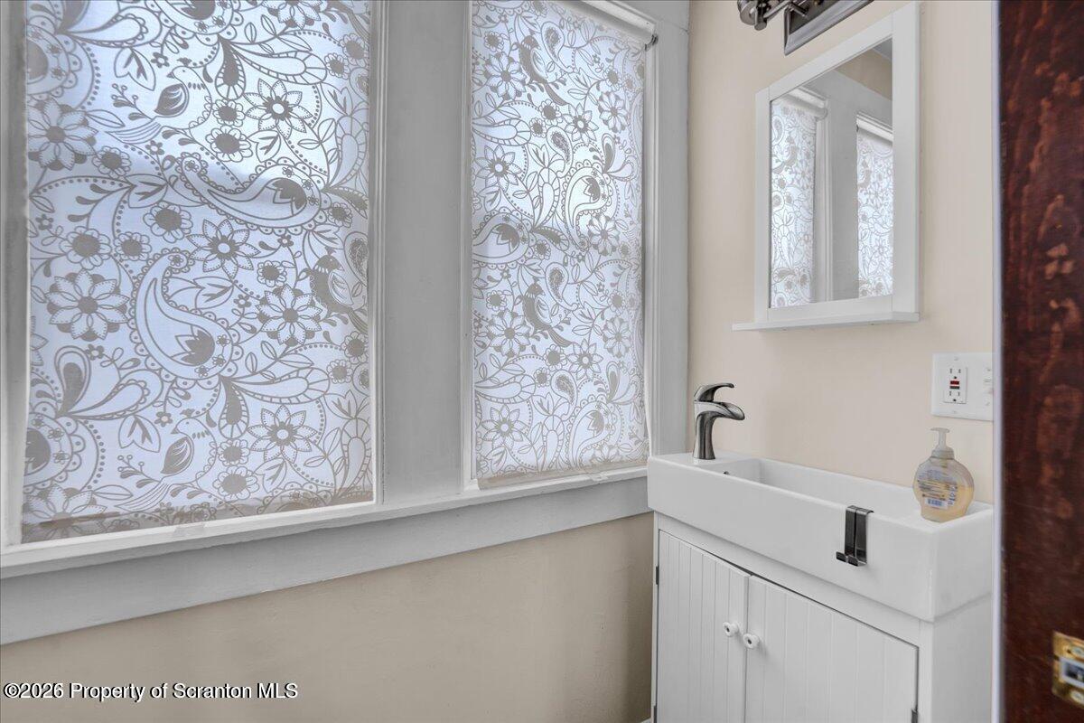1026 Fairfield Street Scranton, PA 18509 - Photo 12 of 26 a bathroom with a sink and a mirror