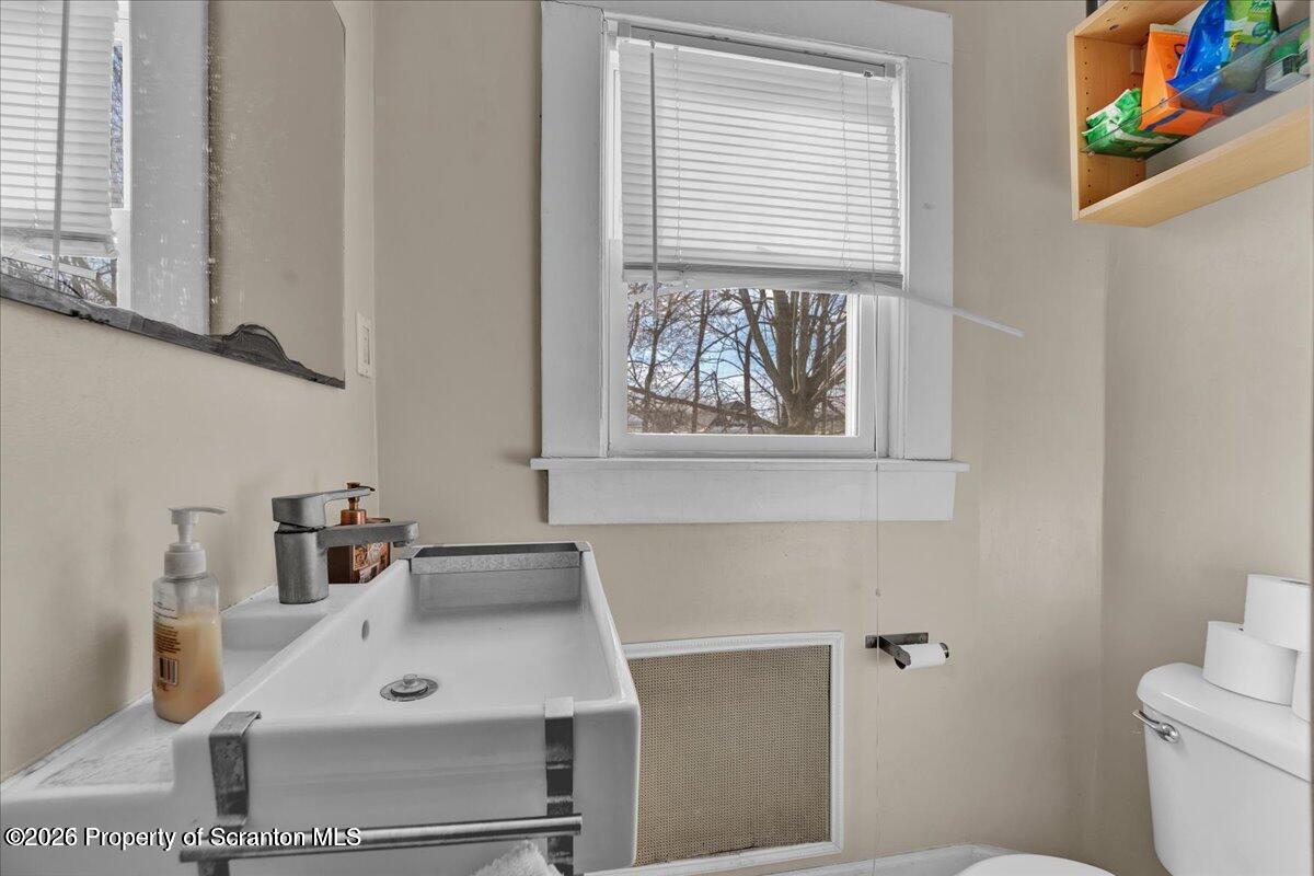 1026 Fairfield Street Scranton, PA 18509 - Photo 18 of 26 a bathroom with a sink and a toilet