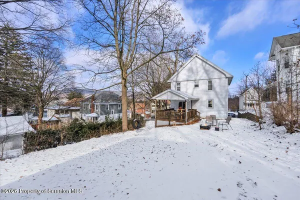 a view of a house with a snow on the road