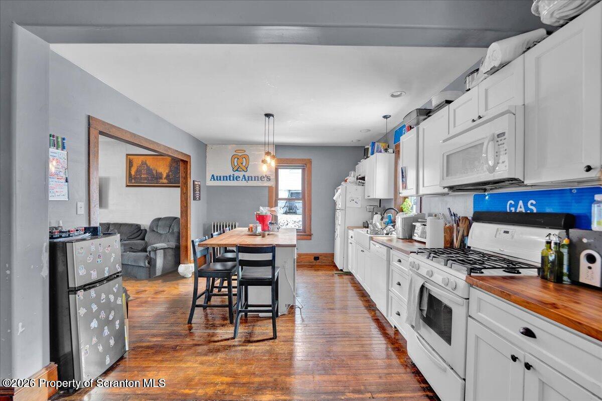 1026 Fairfield Street Scranton, PA 18509 - Photo 5 of 26 a kitchen with stainless steel appliances granite countertop a stove top oven a sink dishwasher and cabinets with wooden floor
