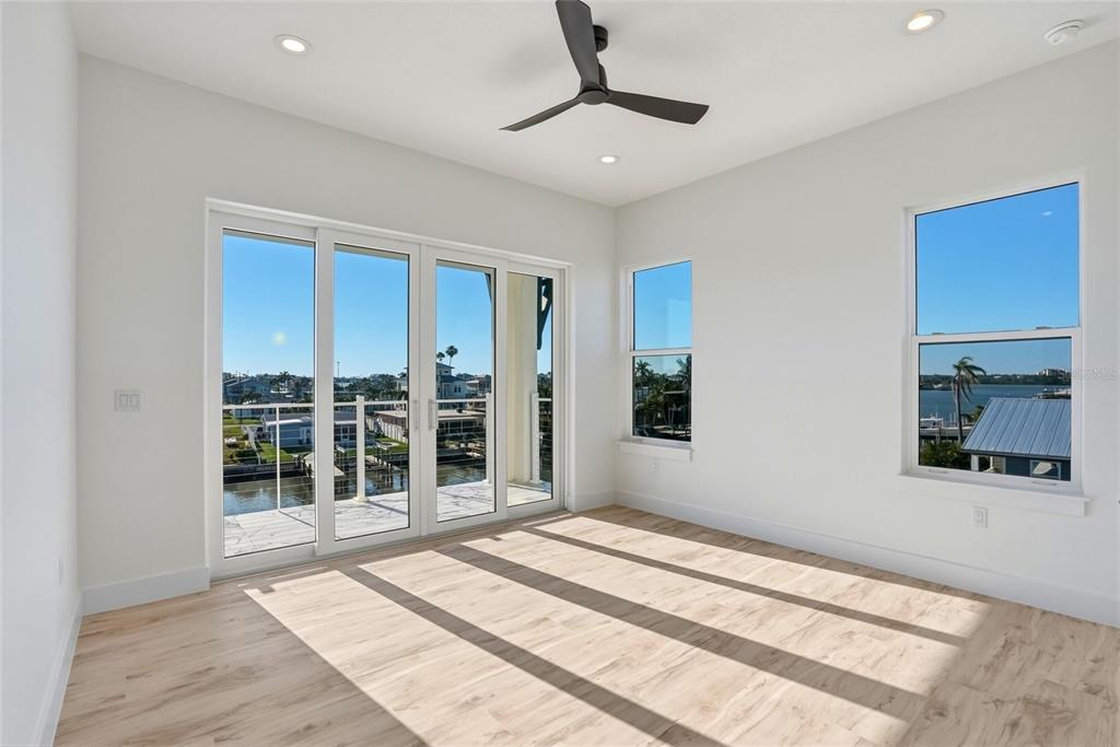 534 Crystal Drive Madeira Beach, FL 33708 - Photo 46 of 68 a bedroom with a bed and a large window