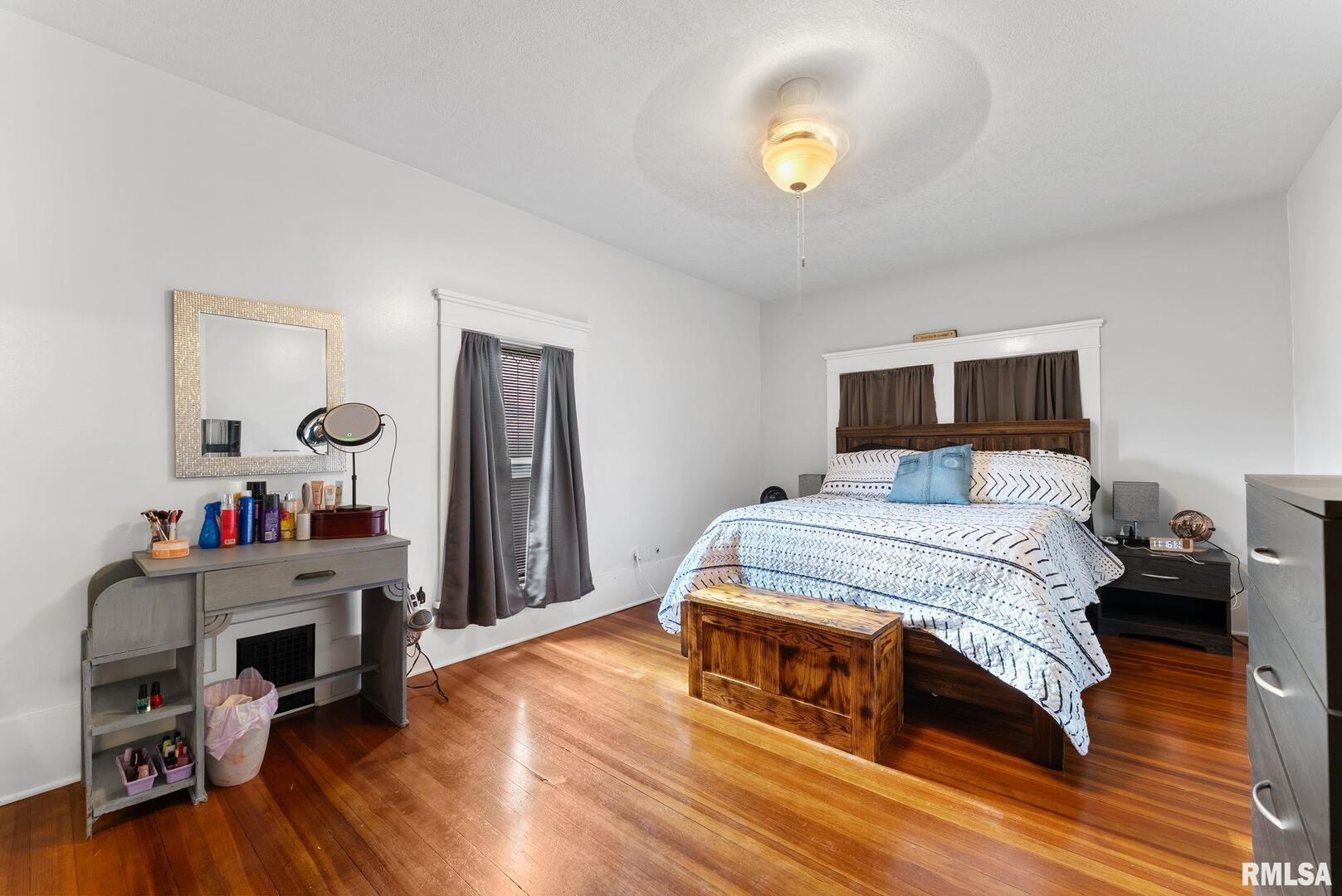 308 Northeast 3rd Avenue Aledo, IL 61231 - Photo 20 of 28 a bedroom with a bed and a wooden floor