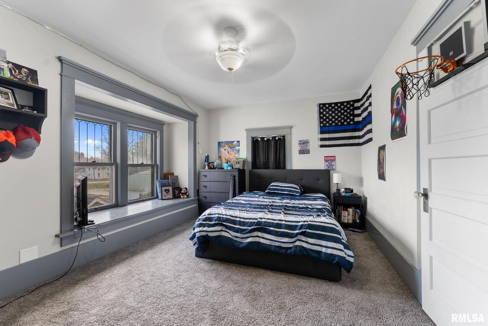 308 Northeast 3rd Avenue Aledo, IL 61231 - Photo 21 of 28 a bedroom with a bed a flat screen tv and balcony