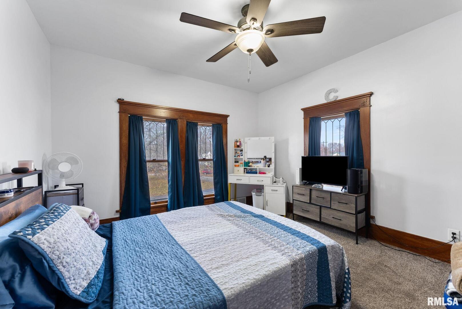 308 Northeast 3rd Avenue Aledo, IL 61231 - Photo 22 of 28 a bedroom with a bed dresser and a flat tv screen